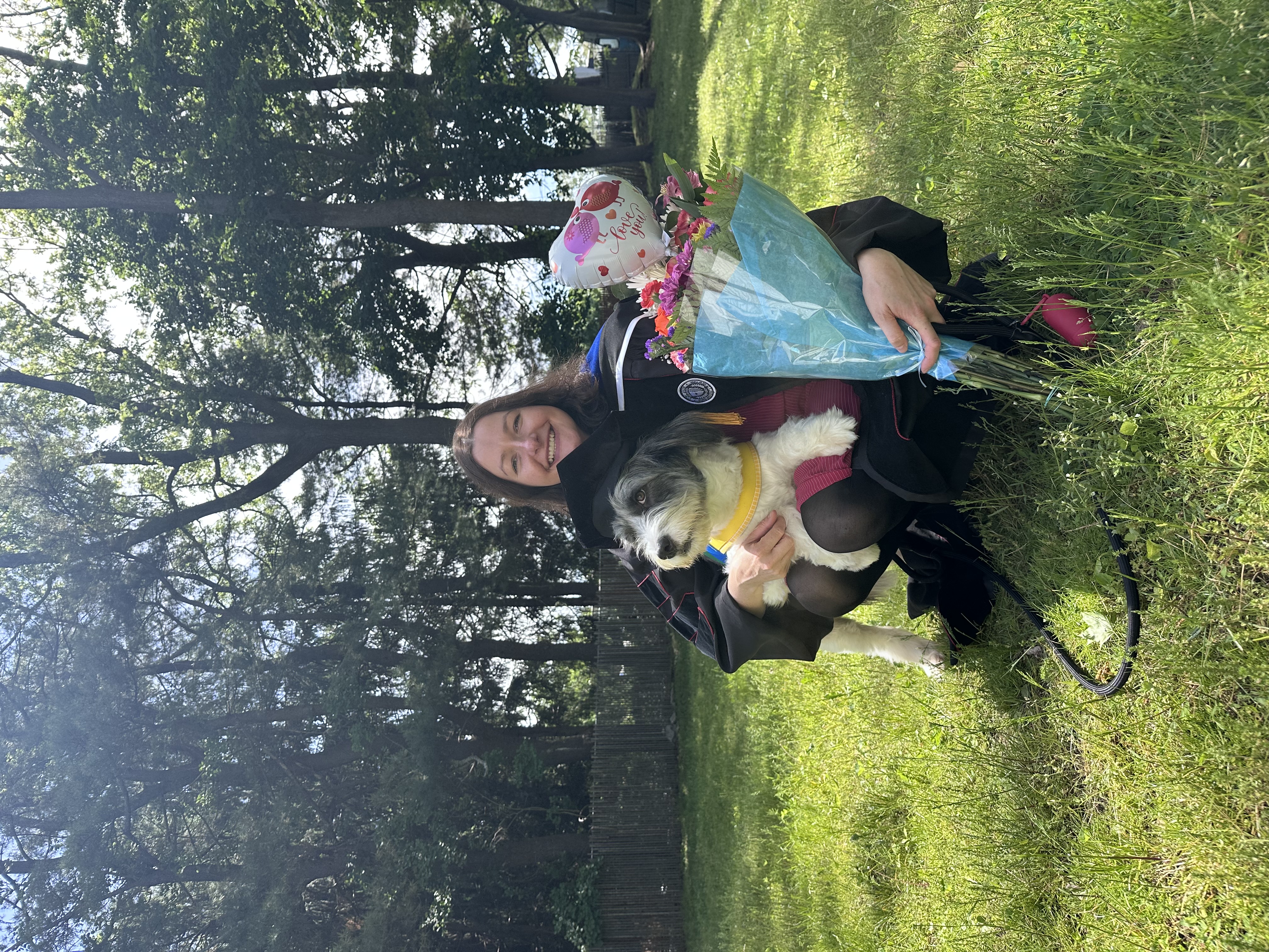 Magdalena Markowska celebrating her graduation with her dog